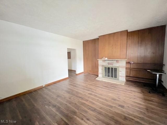 unfurnished living room featuring a fireplace and wood-type flooring