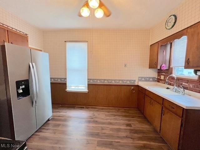 kitchen featuring ceiling fan, stainless steel fridge, dark hardwood / wood-style flooring, and sink