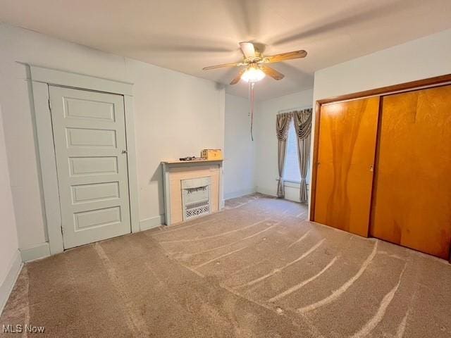 unfurnished bedroom with carpet and ceiling fan