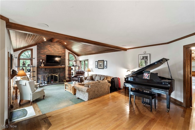 living room featuring wood ceiling, wood-type flooring, a fireplace, vaulted ceiling with beams, and ornamental molding