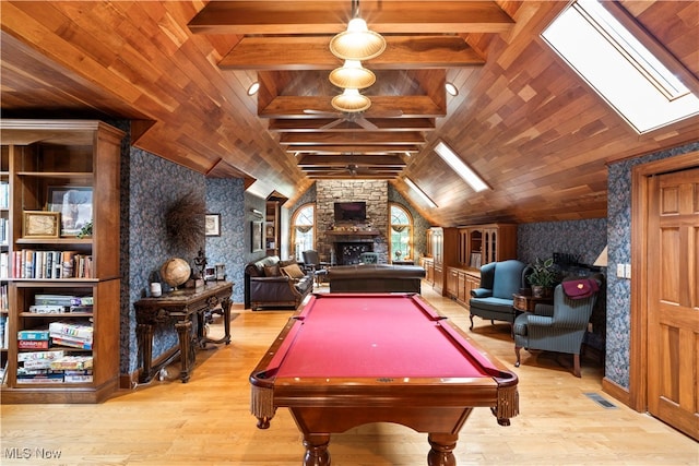 rec room with wood ceiling, a fireplace, lofted ceiling with skylight, and light hardwood / wood-style flooring