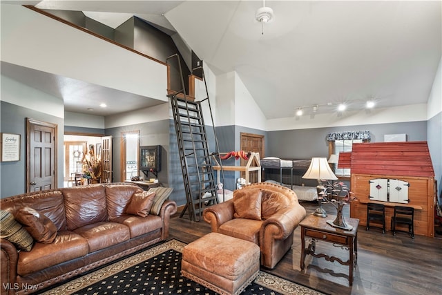 living room featuring lofted ceiling, dark hardwood / wood-style flooring, and a healthy amount of sunlight