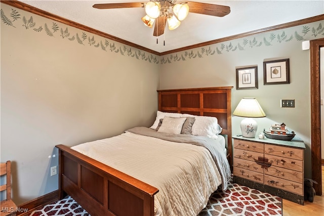 bedroom featuring light hardwood / wood-style flooring, ceiling fan, and crown molding