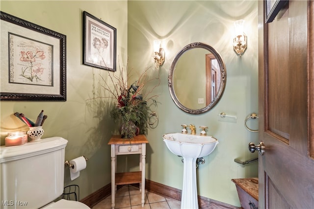 bathroom with toilet and tile patterned floors