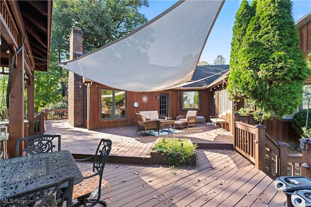 wooden deck with an outdoor living space