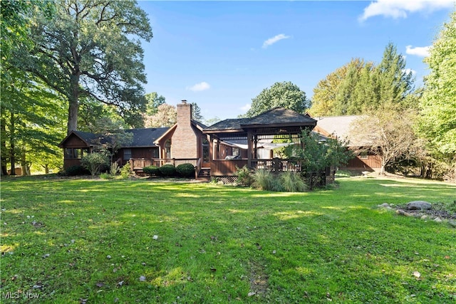 back of house with a lawn, a wooden deck, and a gazebo