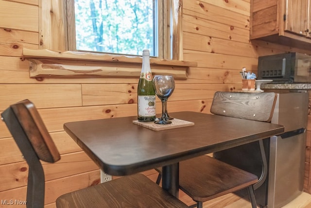 dining area featuring wooden walls