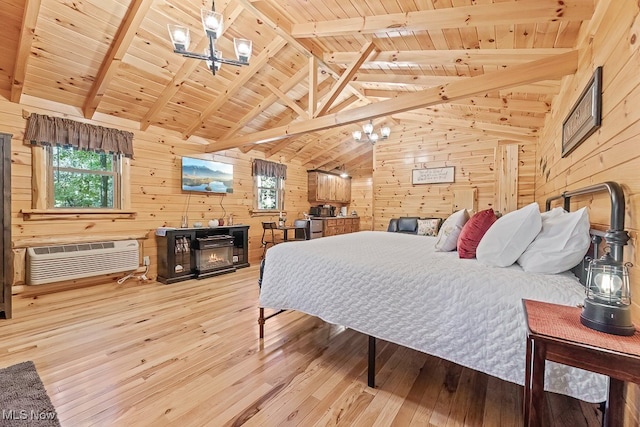 bedroom with vaulted ceiling with beams, wood walls, hardwood / wood-style floors, and an AC wall unit