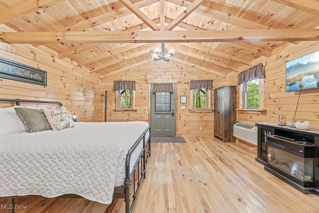 bedroom featuring light hardwood / wood-style flooring, wooden walls, vaulted ceiling with beams, and wooden ceiling