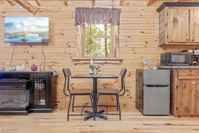 interior space with wooden walls and light hardwood / wood-style floors