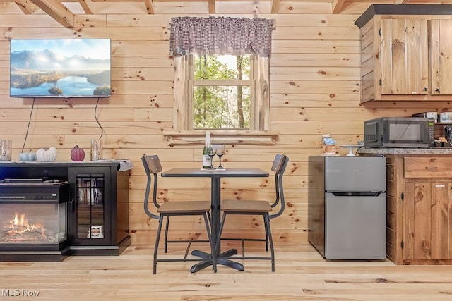 interior space featuring light hardwood / wood-style floors and wooden walls