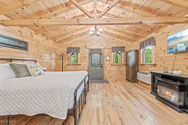 bedroom featuring wooden ceiling, light hardwood / wood-style floors, and wood walls