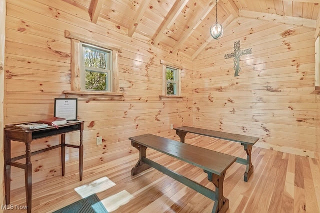 misc room featuring vaulted ceiling with beams, wood ceiling, wooden walls, and light hardwood / wood-style flooring