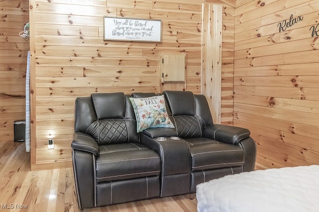 bedroom featuring light hardwood / wood-style flooring and wood walls