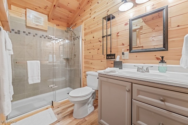 bathroom featuring wood walls, walk in shower, vanity, and toilet