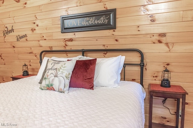 bedroom with wood walls