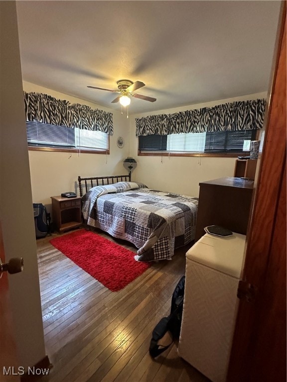 bedroom with hardwood / wood-style floors and ceiling fan