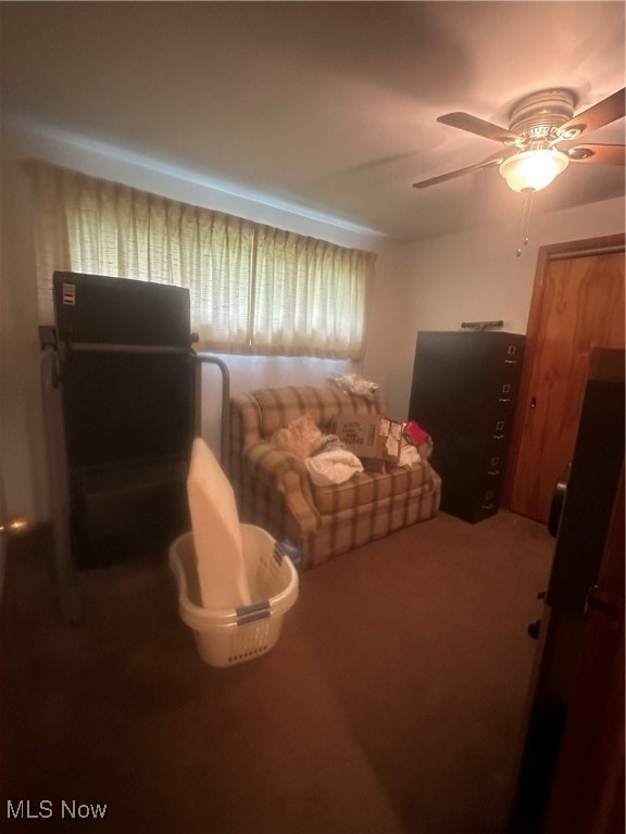 living room with ceiling fan and carpet floors