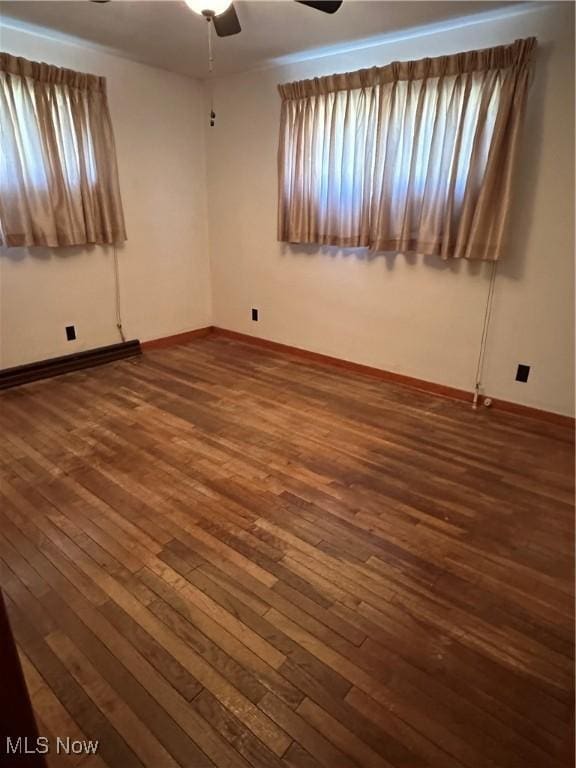 spare room featuring ceiling fan and dark hardwood / wood-style flooring