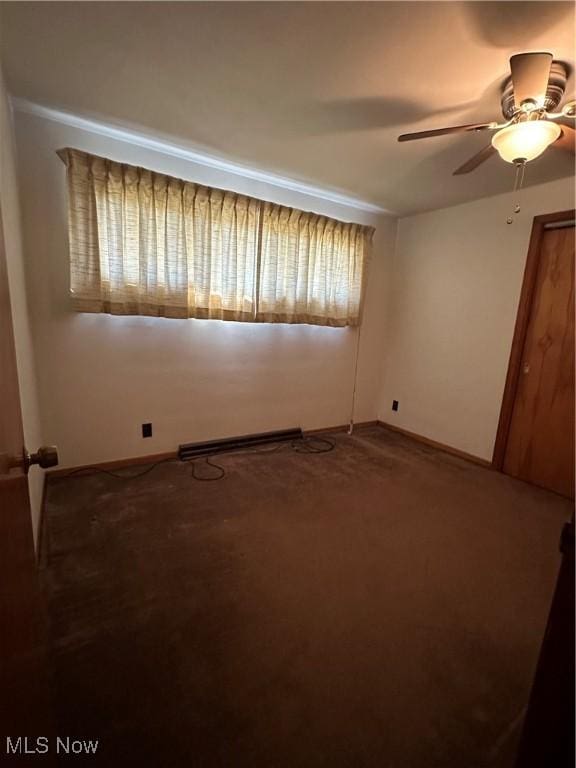 spare room featuring carpet floors, a baseboard radiator, and ceiling fan