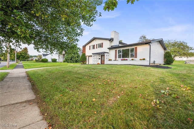 exterior space with a front lawn and a garage