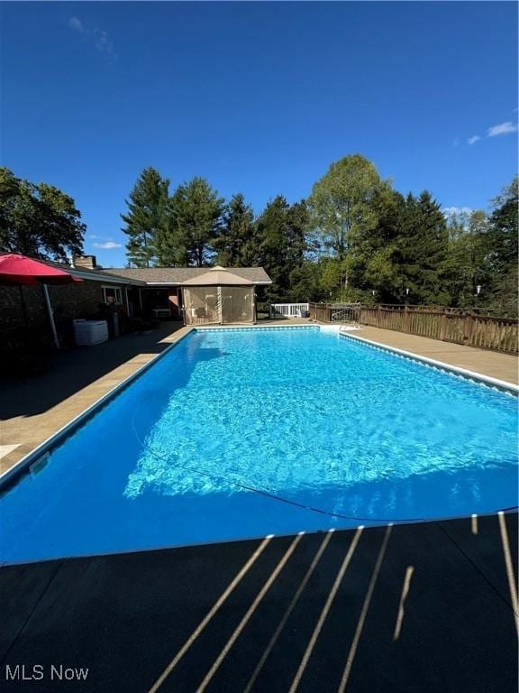 view of swimming pool with fence and a fenced in pool