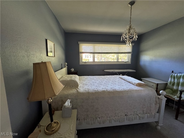 bedroom with carpet flooring and a textured wall