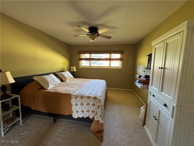 bedroom with carpet floors, a ceiling fan, and baseboards