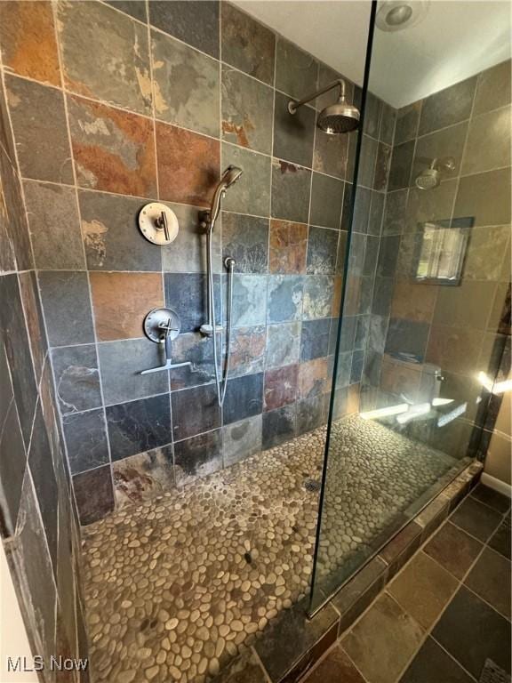 bathroom with a tile shower