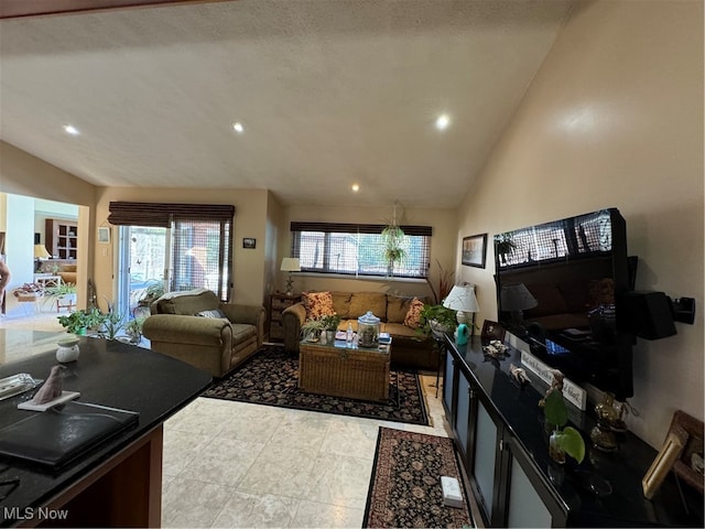 living area with recessed lighting and vaulted ceiling