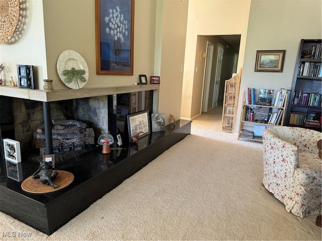 sitting room featuring carpet floors and a tile fireplace