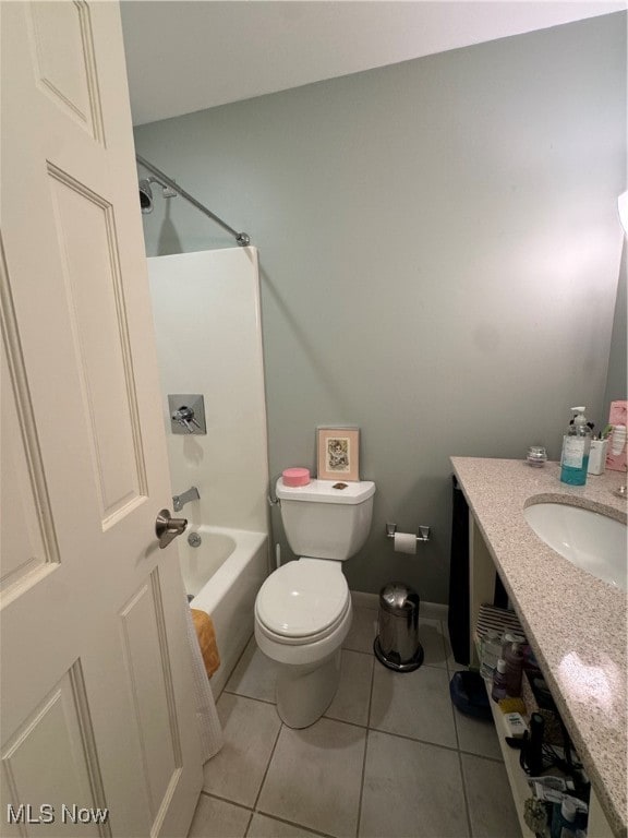 full bath with toilet, tub / shower combination, vanity, baseboards, and tile patterned floors