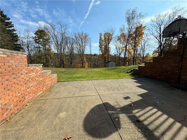 view of patio with an outbuilding and a storage shed