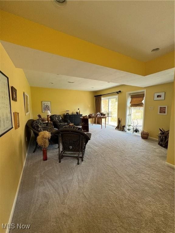 carpeted living room with baseboards