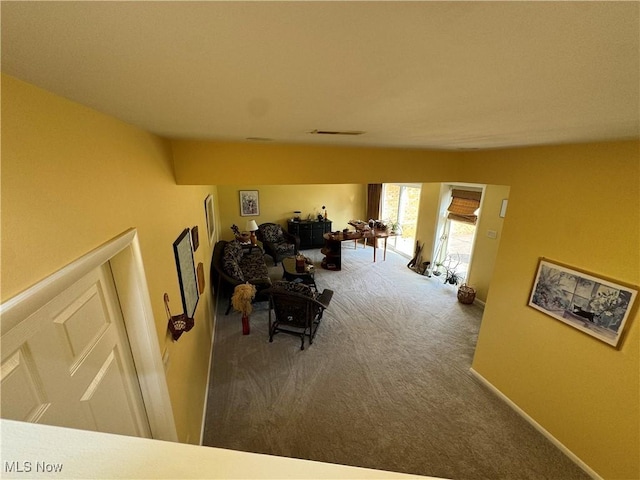 interior space featuring carpet flooring, visible vents, and baseboards