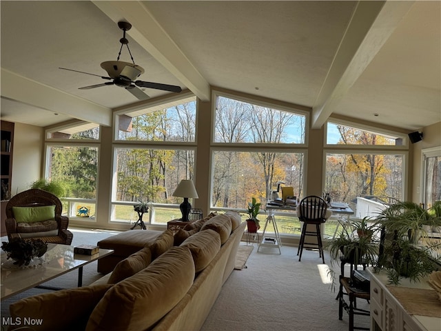 sunroom / solarium with vaulted ceiling with beams and a ceiling fan