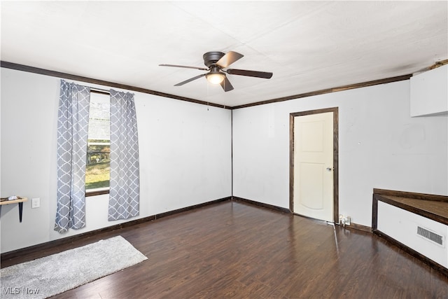 spare room featuring ornamental molding, dark hardwood / wood-style flooring, and ceiling fan