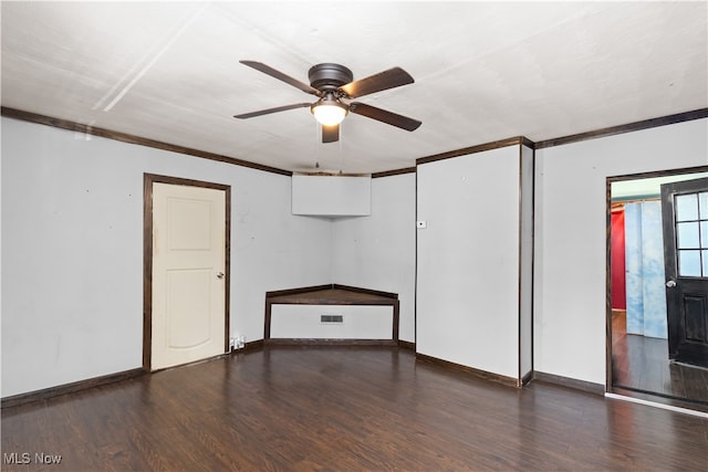 unfurnished room featuring crown molding, ceiling fan, and dark wood-type flooring