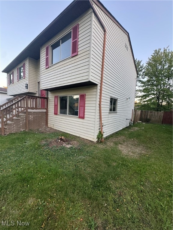 rear view of property featuring a yard