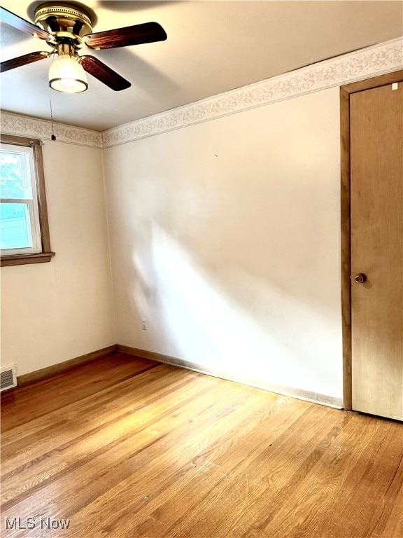 spare room featuring hardwood / wood-style floors and ceiling fan