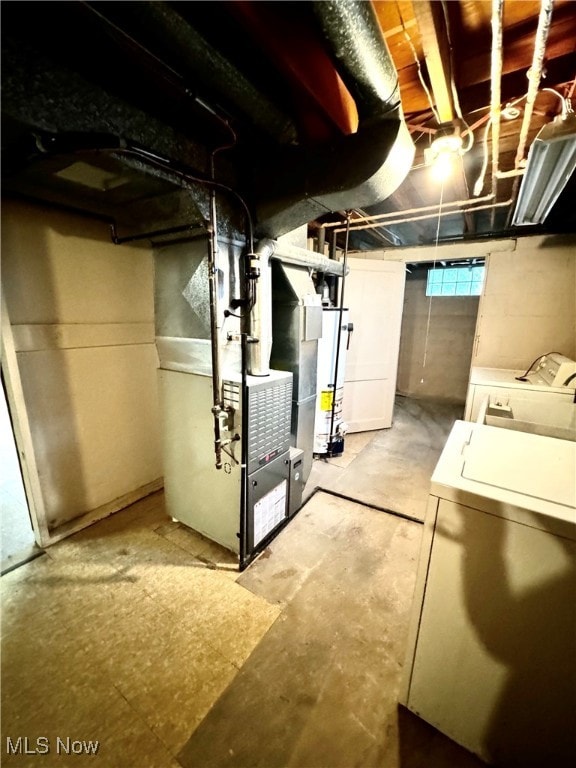 basement with separate washer and dryer, heating unit, and gas water heater