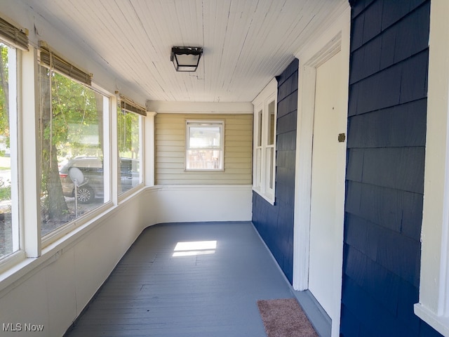 unfurnished sunroom featuring wood ceiling