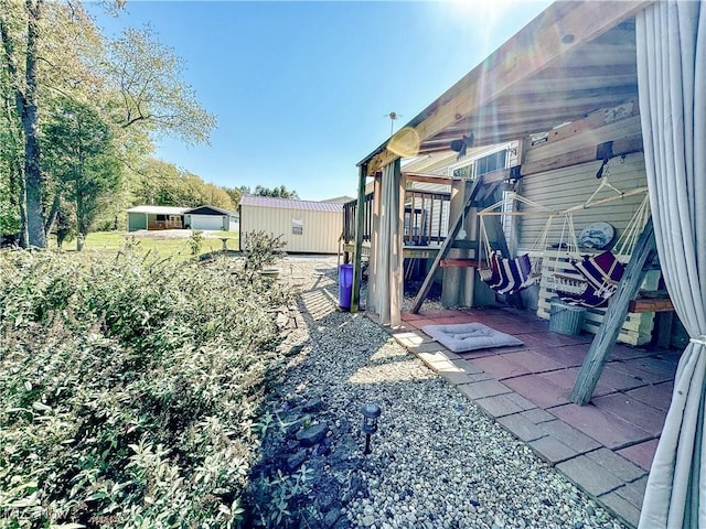 view of yard with a patio area and an outdoor structure