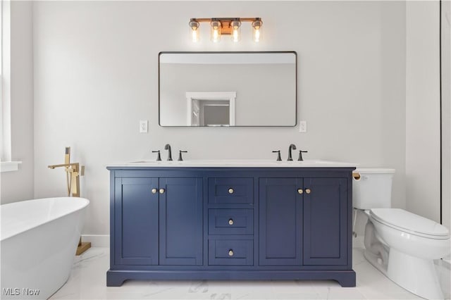 bathroom featuring a bathtub, toilet, and vanity