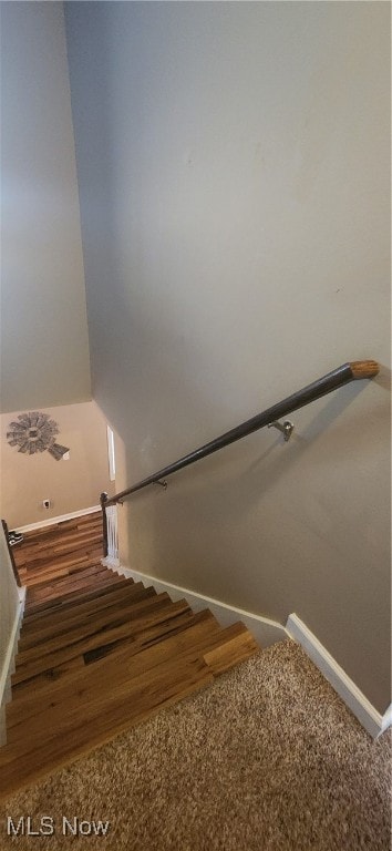 stairs featuring wood-type flooring