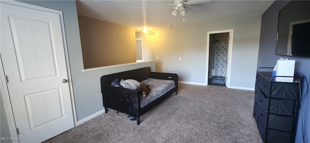 sitting room with ceiling fan, carpet floors, and a textured ceiling