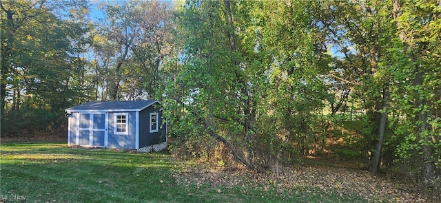 view of outdoor structure featuring a lawn