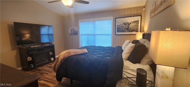 bedroom with lofted ceiling, ceiling fan, and hardwood / wood-style floors