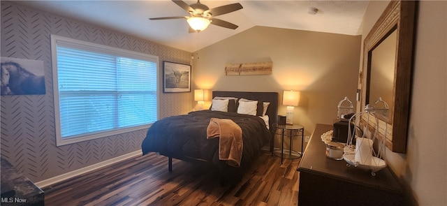 bedroom featuring lofted ceiling, multiple windows, ceiling fan, and dark hardwood / wood-style flooring