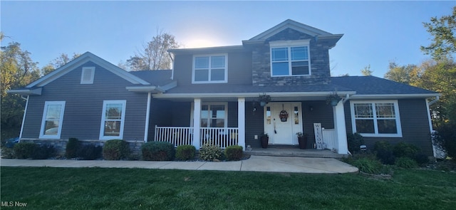 view of property with a front yard and covered porch